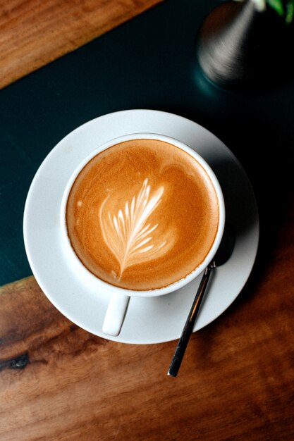 Top view cup of cappuccino with a petal pattern