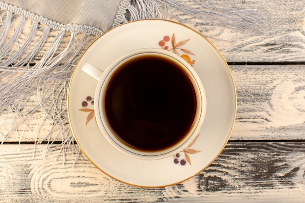 Top view of cup of coffee hot and strong on the grey wooden desk