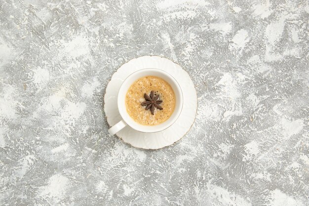 Top view cup of coffee on the white desk