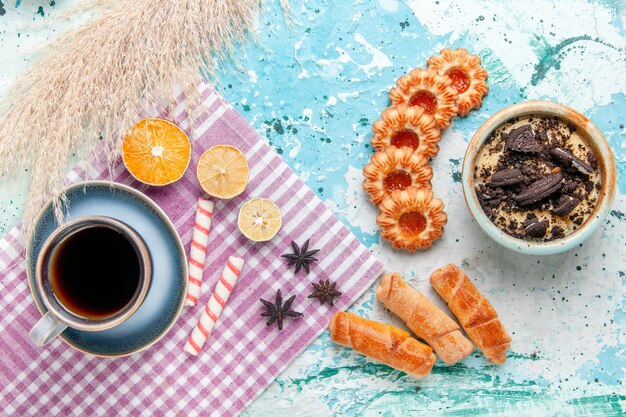 Top view cup of coffee with bagels and cookies on light-blue desk cake bake sweet sugar pie biscuit