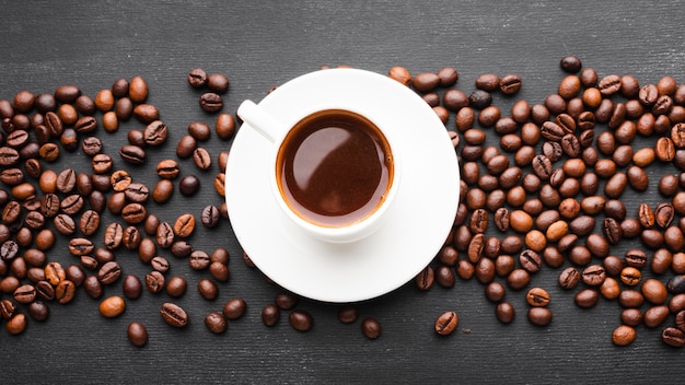 Top view cup of coffee with beans