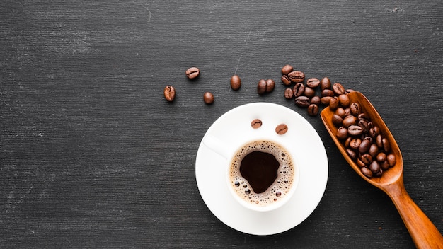 Top view cup of coffee with beans