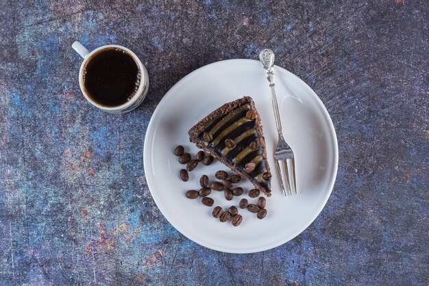 Top view of cup of coffee with chocolate cake slice