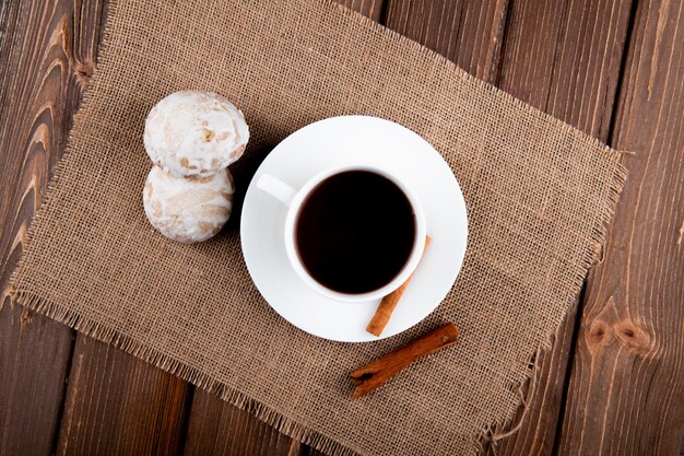 top view Cup of coffee with cinnamon and gingerbread on wooden table