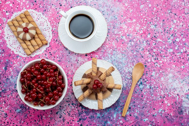 Top view cup of coffee with cookies cranberries on the colored background cracker sugar powder