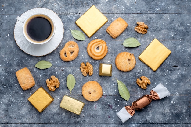 Free photo top view of cup of coffee with cookies walnuts on grey desk, cookie biscuit sugar sweet