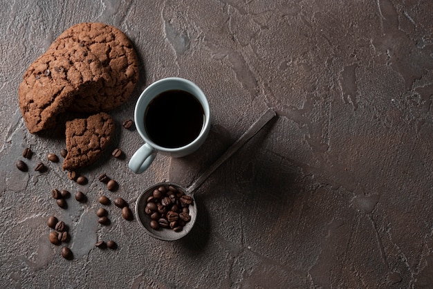 Top view cup of coffee with cookies