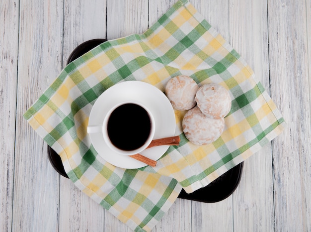 top view Cup of coffee with gingerbreads and cinnamon on tablecloth