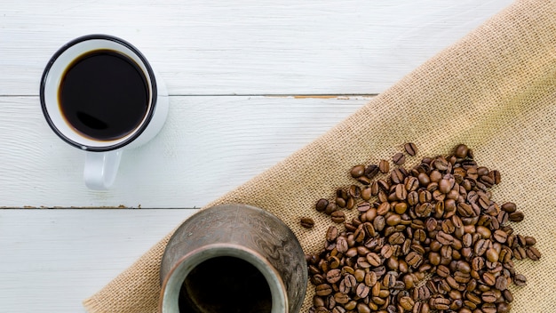 Top view cup of coffee with grains