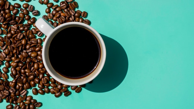 Top view cup of coffee with grains