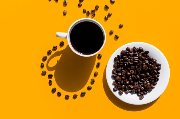 Top view cup of coffee with grains