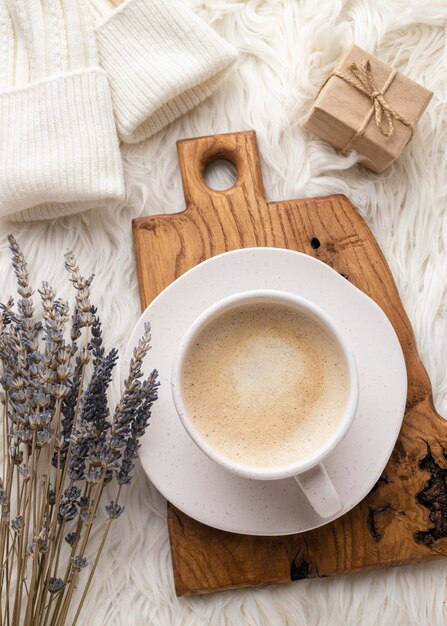 Top view of cup of coffee with lavender and present