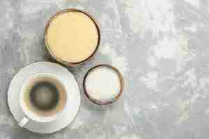 Free photo top view of cup of coffee with sugar and dessert