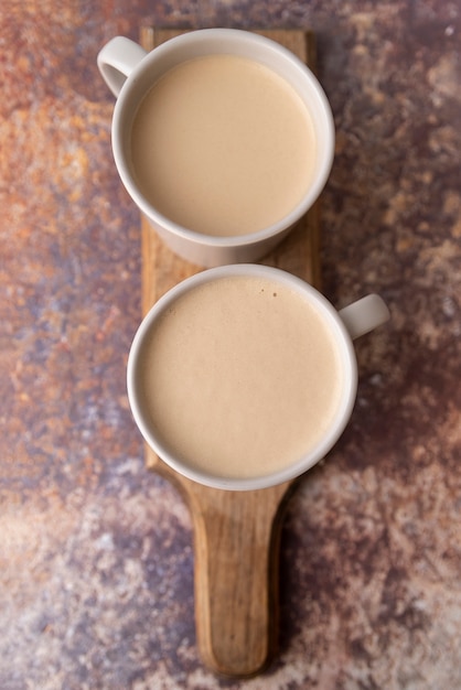 Top view cup of coffee on wooden board