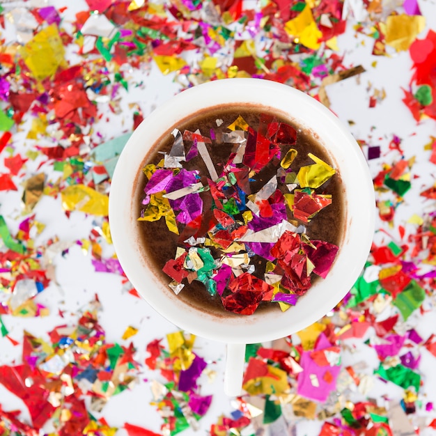 Free photo top view cup full of colorful confetti