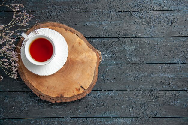 Top view cup of tea on a dark table