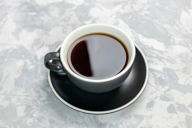 Top view cup of tea inside cup and plate on white surface