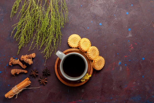 Top view cup of tea inside plate and cup on dark background tea drink color photo sweet