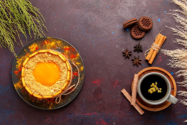 Top view cup of tea inside plate and cup on dark background tea drink color photo sweet