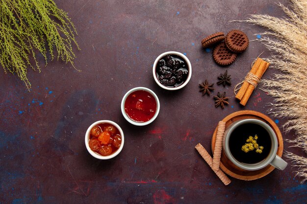 Top view cup of tea inside plate and cup on dark background tea drink color photo sweet