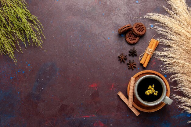 Top view cup of tea inside plate and cup on dark background tea drink color photo sweet