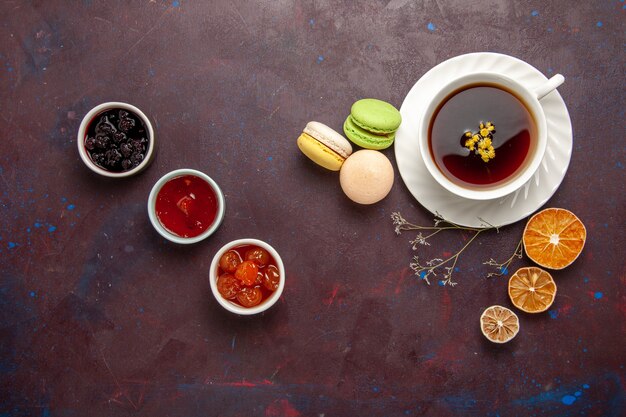 top view cup of tea inside plate and cup on dark background tea drink color photo sweet