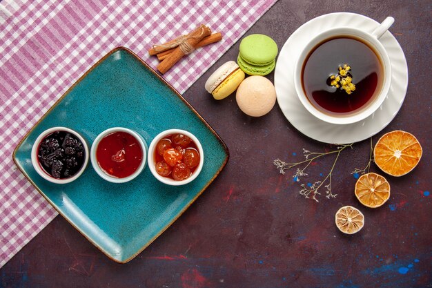 Top view cup of tea inside plate and cup on dark background tea drink color photo sweet