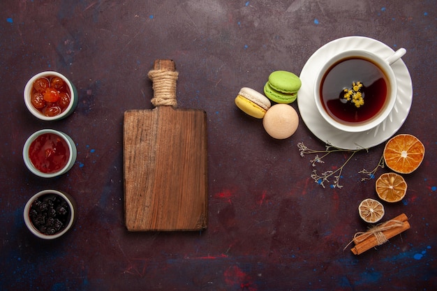 Top view cup of tea inside plate and cup on dark background tea drink color photo sweet