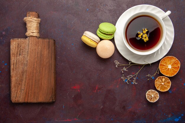 Free photo top view cup of tea inside plate and cup on dark background tea drink color photo sweet