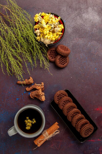 Top view cup of tea inside plate and cup on dark surface tea drink color photo sweet