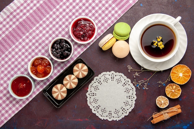 Top view cup of tea inside plate and cup on dark surface tea drink color photo sweet