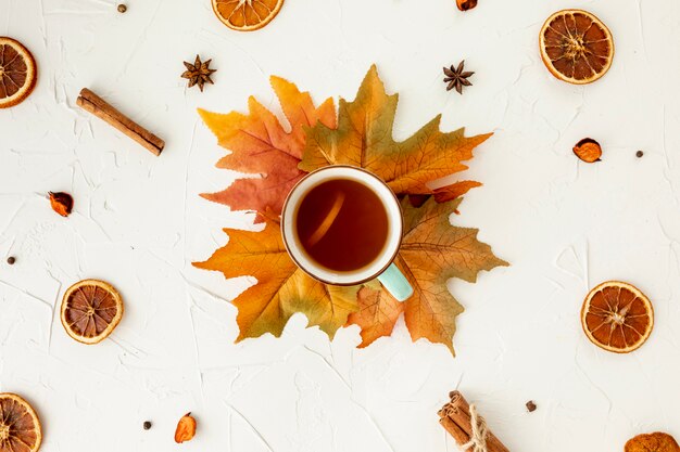 Top view cup of tea on leaf