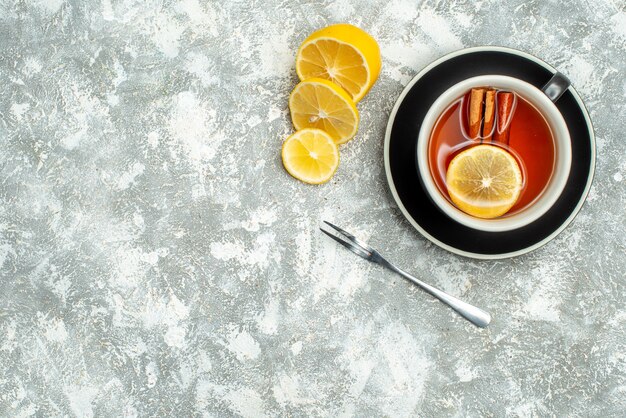 Top view a cup of tea lemon slices on grey surface free space