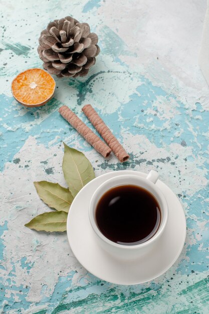 Top view cup of tea on light-blue surface