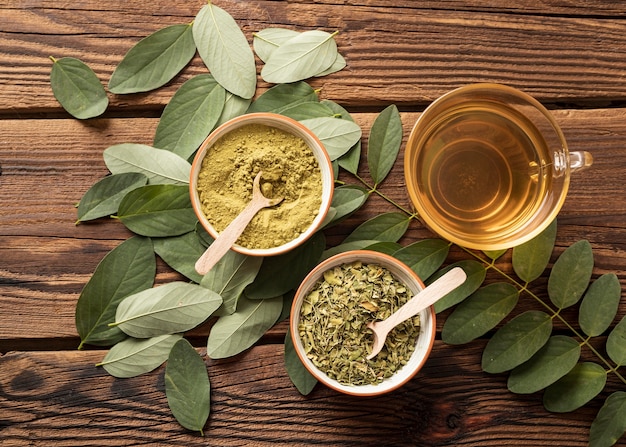 Free photo top view cup of tea and natural herbs leaves
