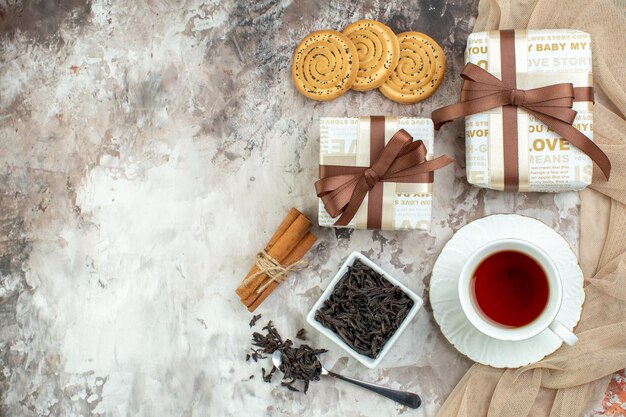 Top view cup of tea with biscuits and present on a light background valentines day feeling love sweet marriage cookie sugar couple