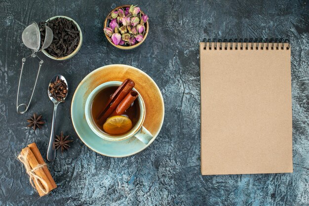 Top view cup of tea with black tea and dried flowers on light background tea photo coffee color ceremony breakfast fruit