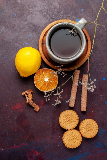 Top view cup of tea with cinnamon and cookies on dark surface cookie biscuit sugar pie sweet