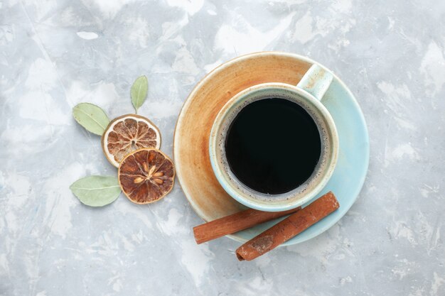 Top view cup of tea with cinnamon on the white surface drink tea cinnamon lemon color