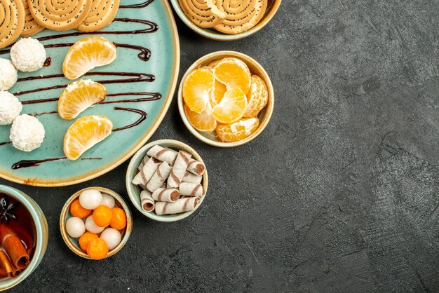 Top view cup of tea with cookies and candies on grey table cookie cake biscuit