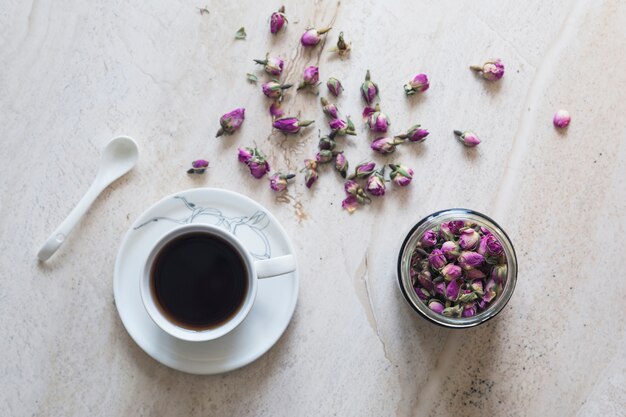 Top view cup of tea with cup of flores