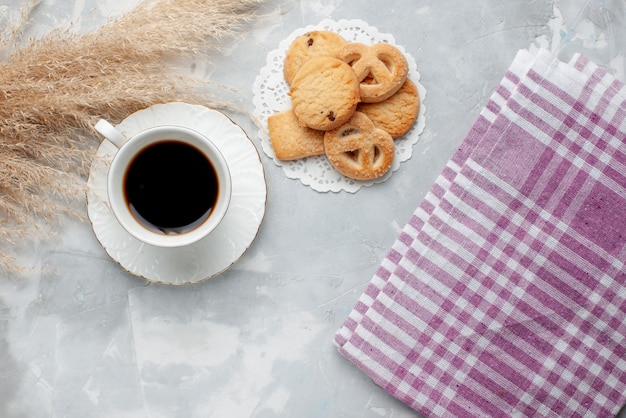 Top view of cup of tea with delicious little cookies on light, cookie biscuit sweet tea sugar