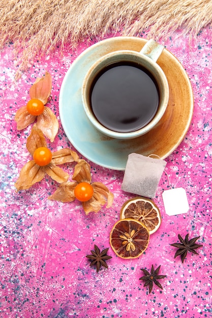 Top view cup of tea with flavor on pink desk.