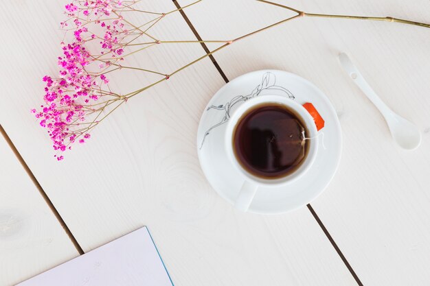 Top view cup of tea with flowers