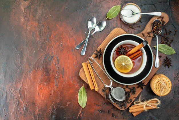 Top view cup of tea with fresh black tea on dark brown background ceremony tea breakfast water color photo drink