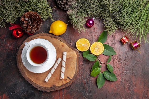 Top view cup of tea with fruits on dark table fruits tea photo dark