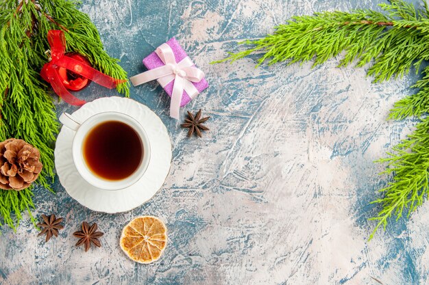 Top view cup of tea with green branch