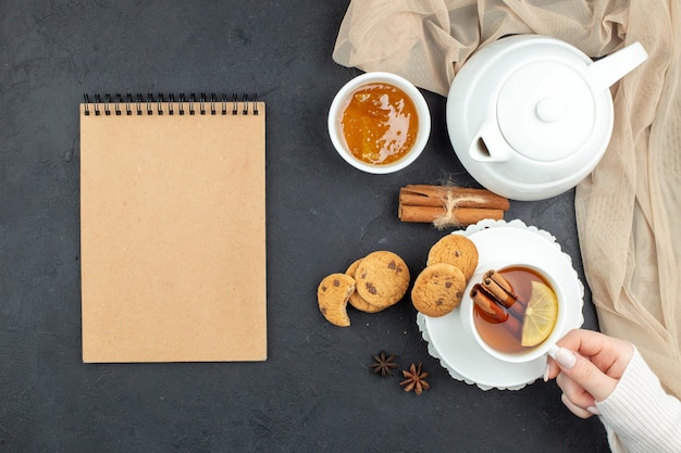 Top view cup of tea with honey and biscuits on a dark background lunch meal ceremony breakfast food color lemon cookie