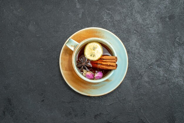 Top view cup of tea with lemon and cinnamon on a grey background tea drink fruit lemon