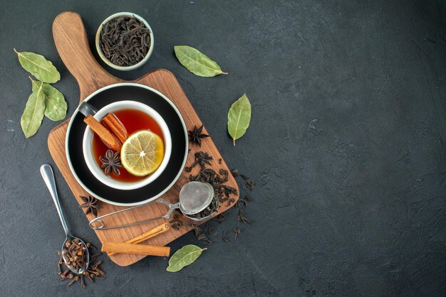 Top view cup of tea with lemon and fresh black tea on dark background ceremony tea breakfast water drink color photo